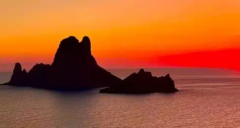 es vedra ibiza seen from left side during sunset with orange background